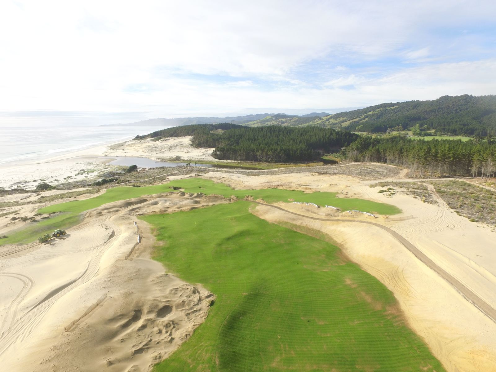 Aerial view of a green set among sand dunes